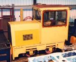 side view of the bright yellow loco in the shed