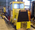 front view of the bright yellow loco in the shed