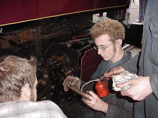 Volunteers Tim, Daffy and Gordon working on Russell.  [Andy Goodwin]