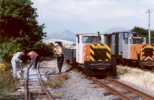 two Barclays side by side, each with a works train; the track gang are working on the left