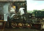 young man standing on the loco with cleaning spray