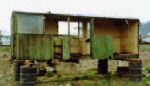 decrepit body of the wooden coach standing on barrels on open ground