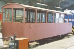 nearly-restored coach, painted in pinkish undercoat