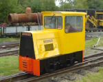 bright yellow loco running through the yard